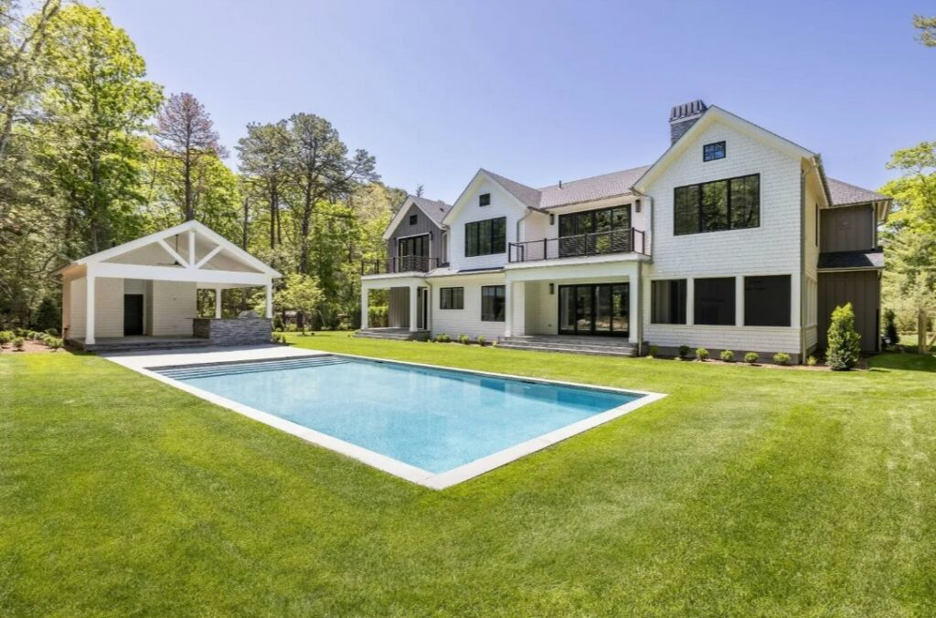 a pool in the yard of a newly built home