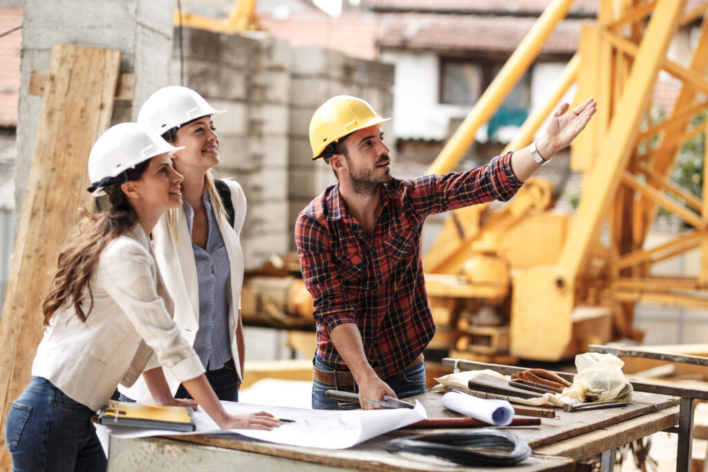 Construction team reviewing plans and progress on job site