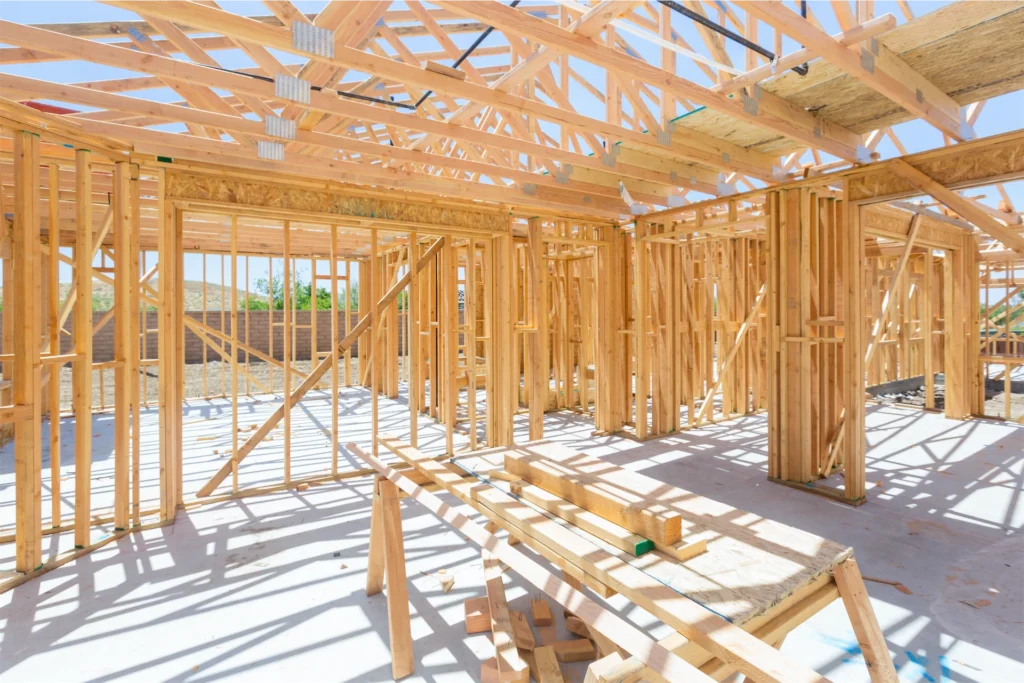 Interior framing of new home showing wood trusses