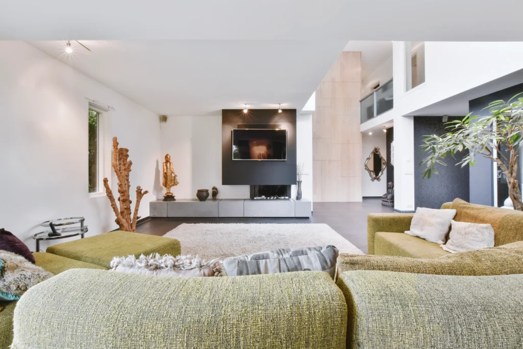 Spacious modern living room with green sectional sofa