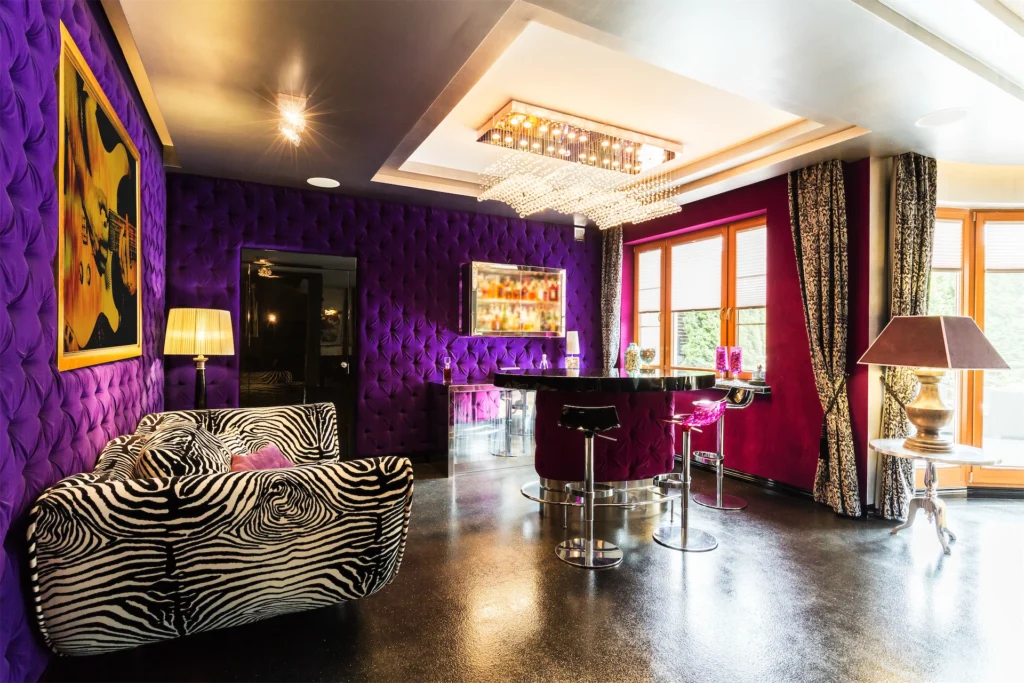 Bold purple living room with bar area and zebra sofa