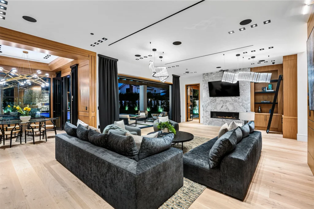 Modern open living space with fireplace and designer seating