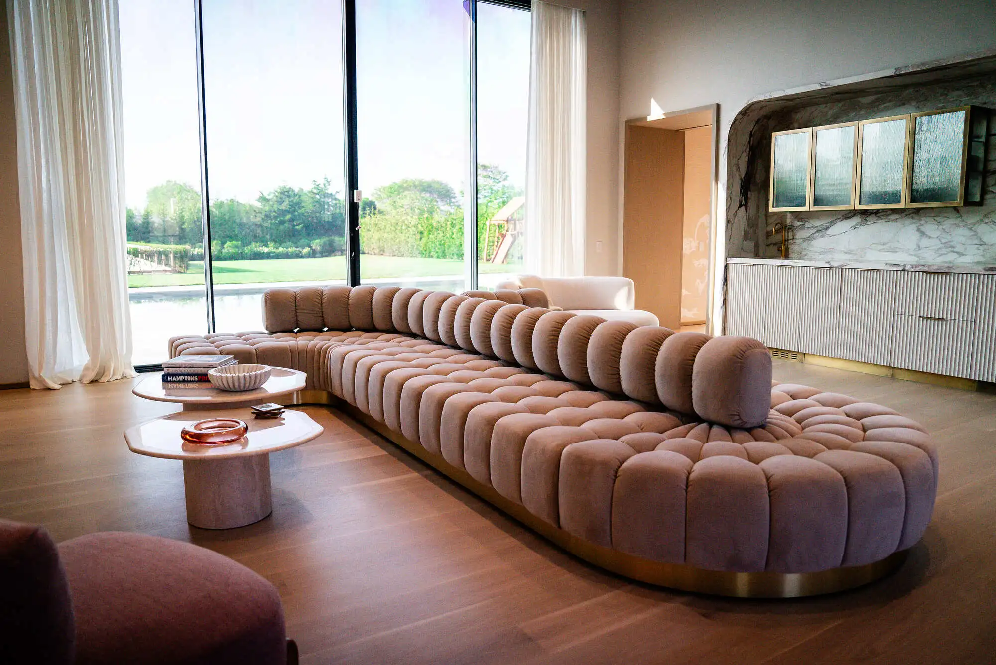 Elegant great luxury renovated room with curved sofa and tall windows