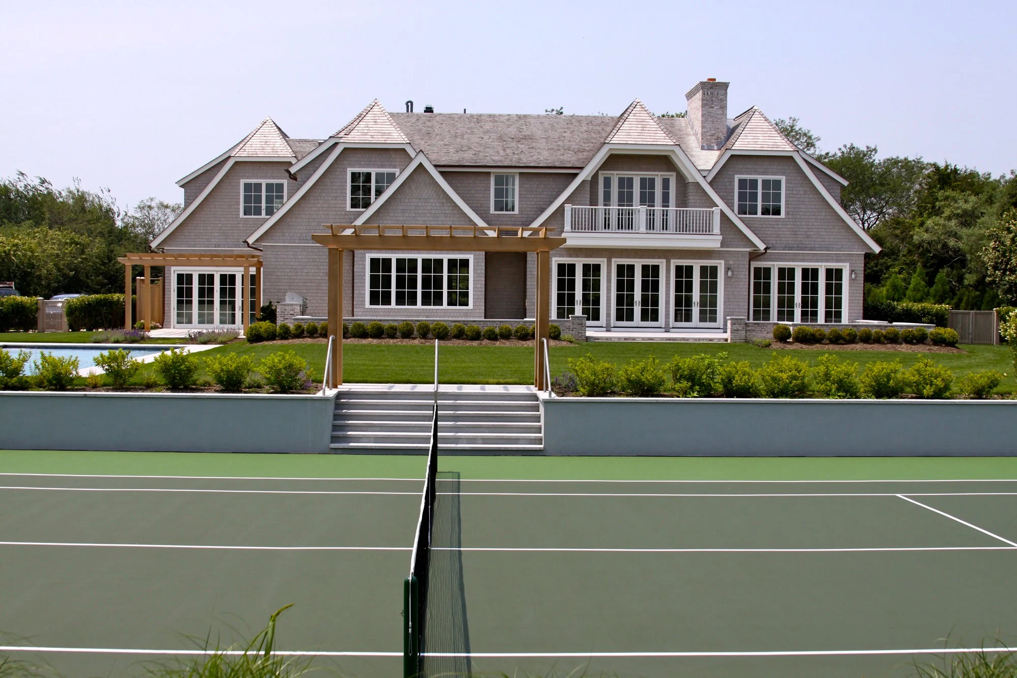 Luxury home with tennis court and landscaped backyard
