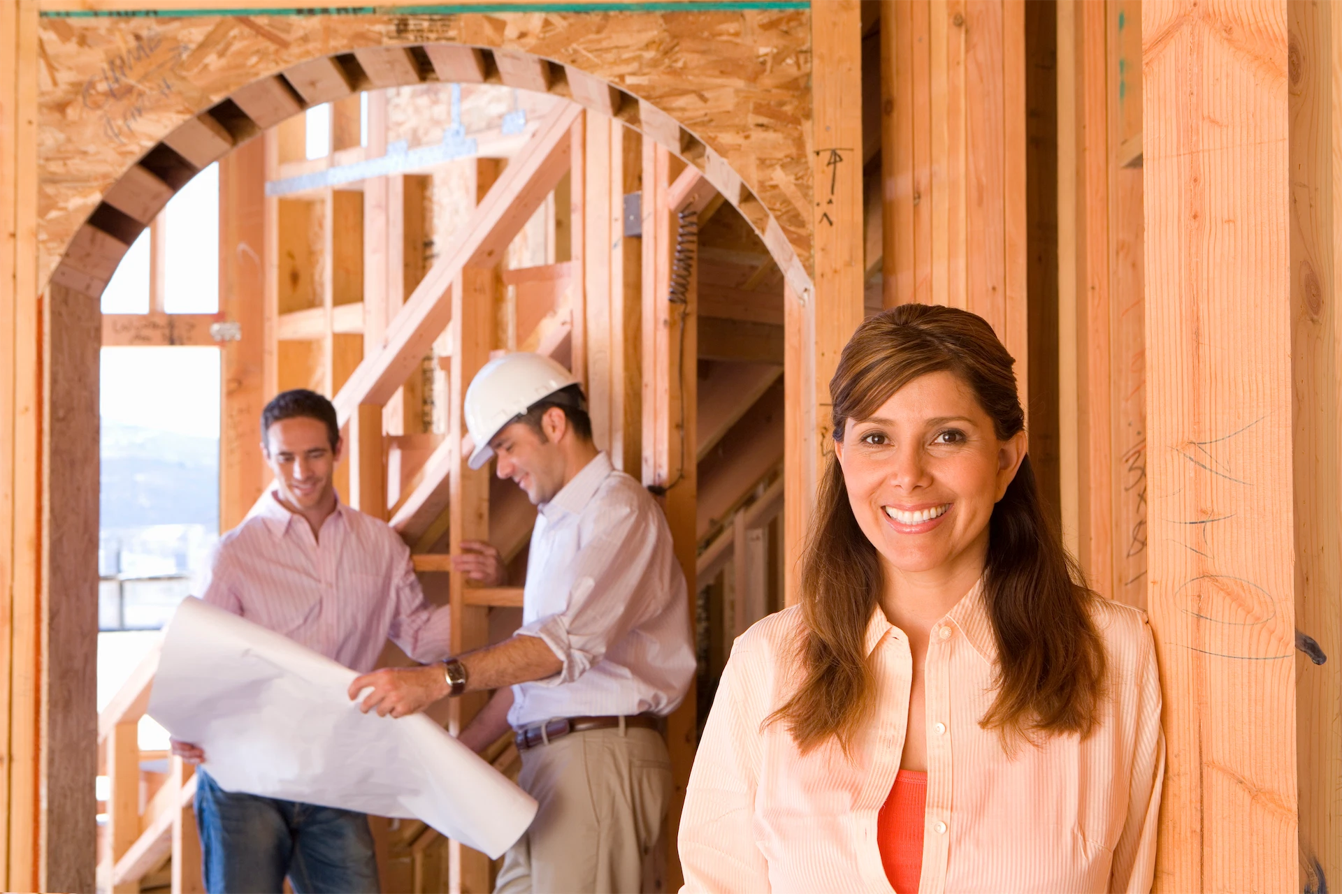 Homeowner reviewing plans with builders and owner's representative