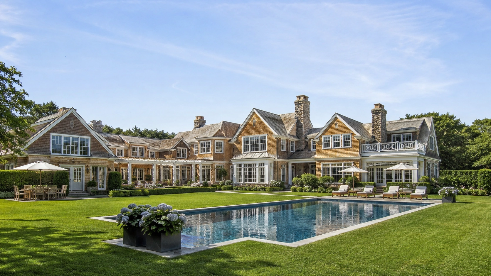 Completed luxury Hamptons estate featuring landscaped grounds, pool, and custom architecture