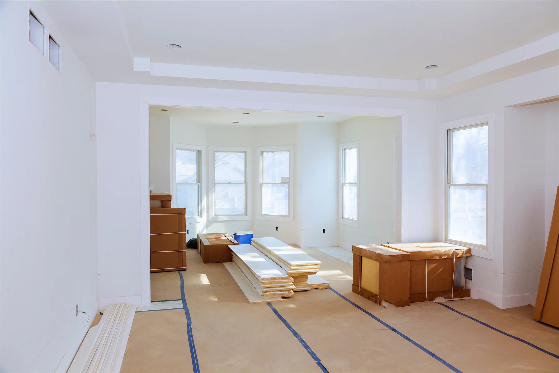 Luxury home renovation interior with fresh paint, new moldings, and building materials ready for installation