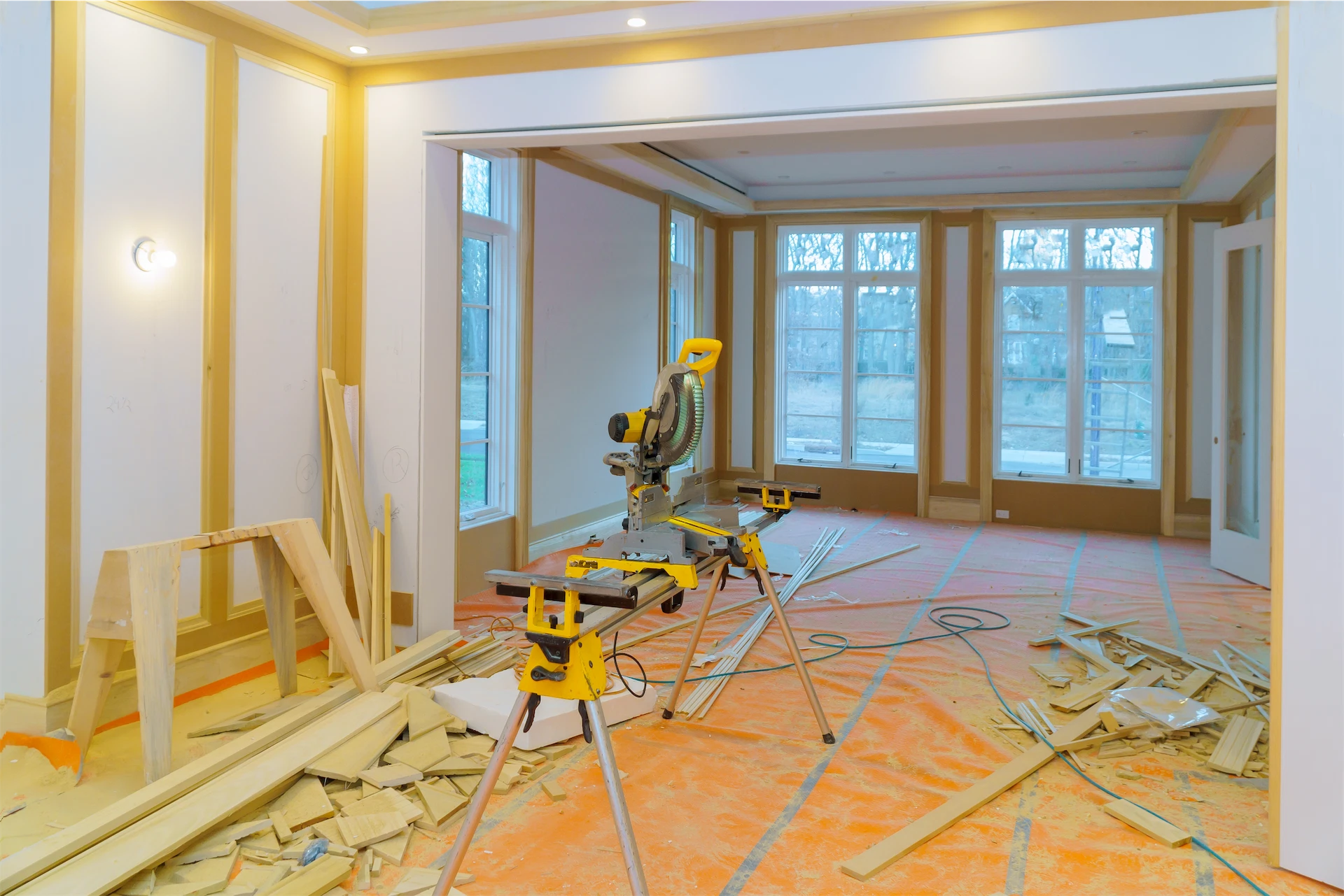 Luxury home renovation project with power saw, wood trim, and interior finishing work in progress